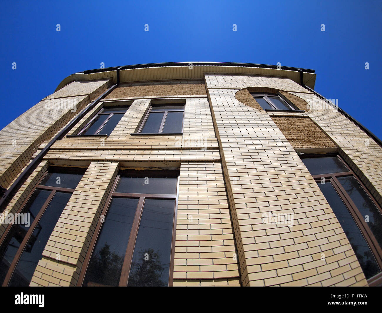 New office building, view from below against the bright blue sky with wide angle fisheye lens and distortion view Stock Photo