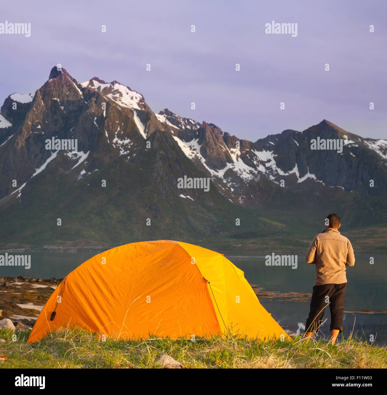 tourist tent on ocean beach and mountains Stock Photo