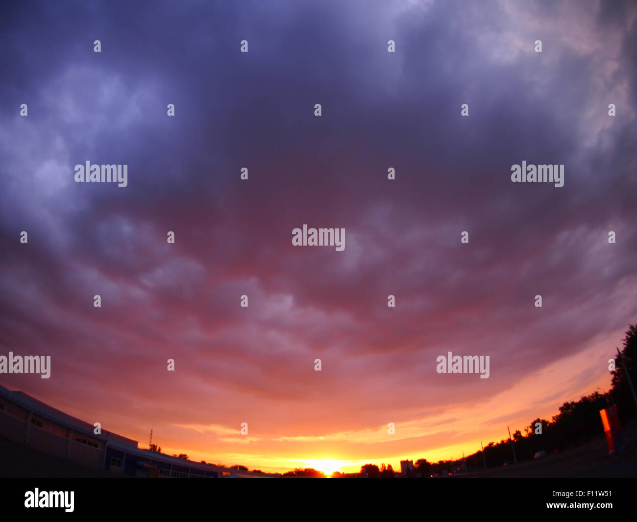 The sky with clouds over the city before sunset with wide angle fisheye ...