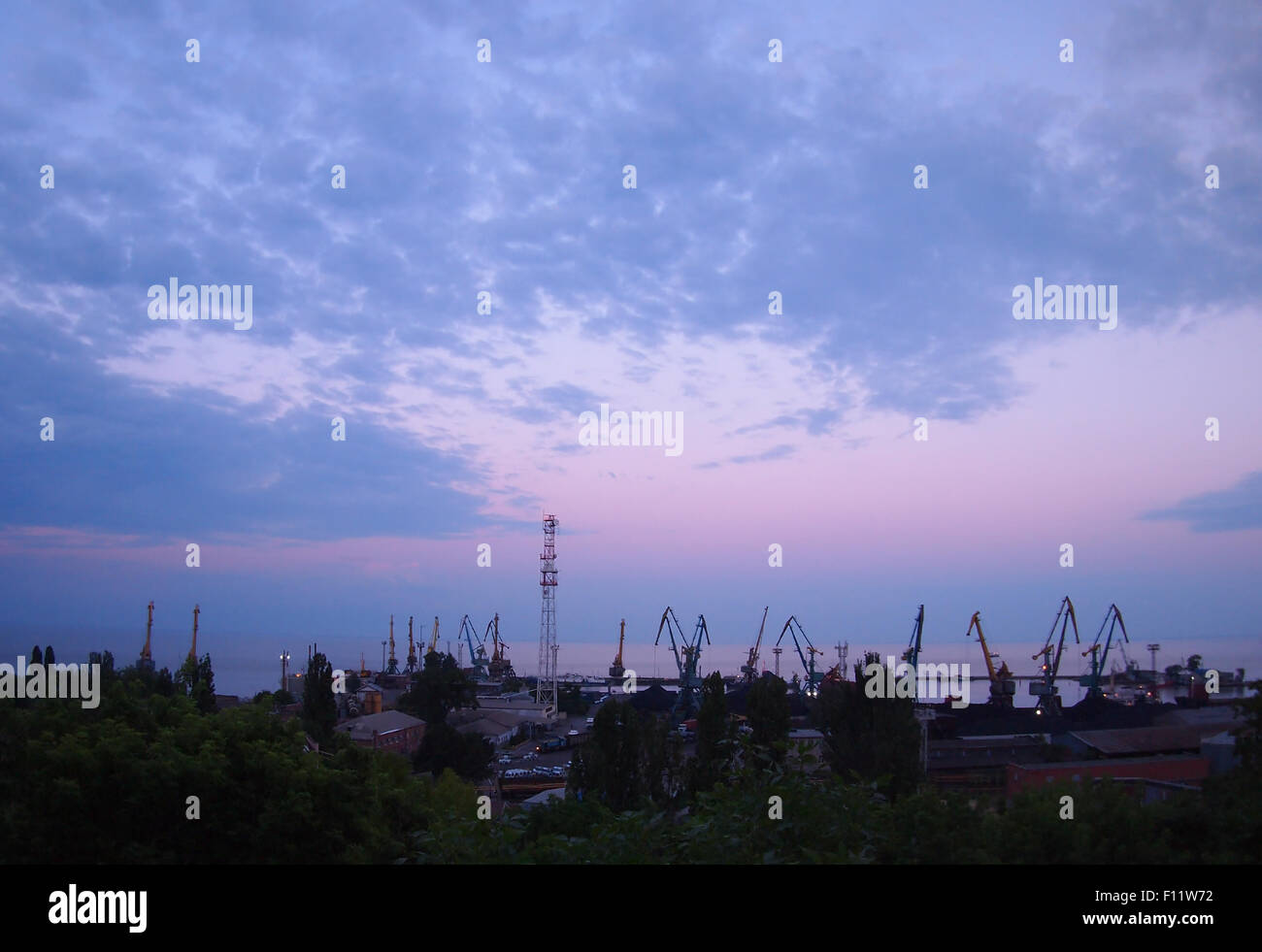 View of a cargo seaport against the evening cloudy sky with wide angle distortion view Stock Photo