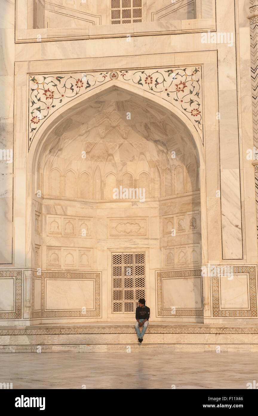 Agra, Uttar Pradesh, India. A man sitting in the alcove of the Taj mahal. Stock Photo