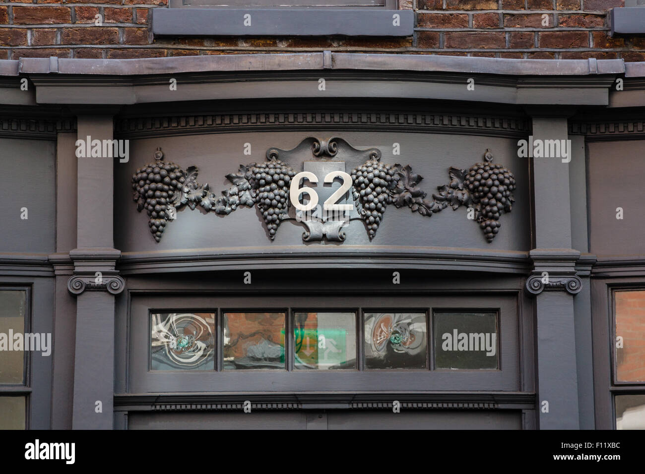 Ornate carving of grapes over door of No 62 Dean Street, Soho, London. Stock Photo