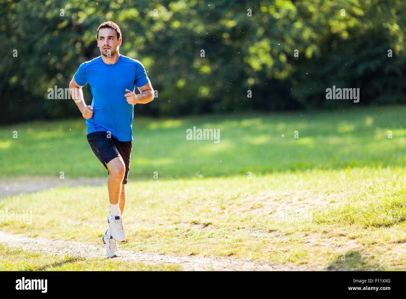 Young fit athlete jogging outdoors Stock Photo