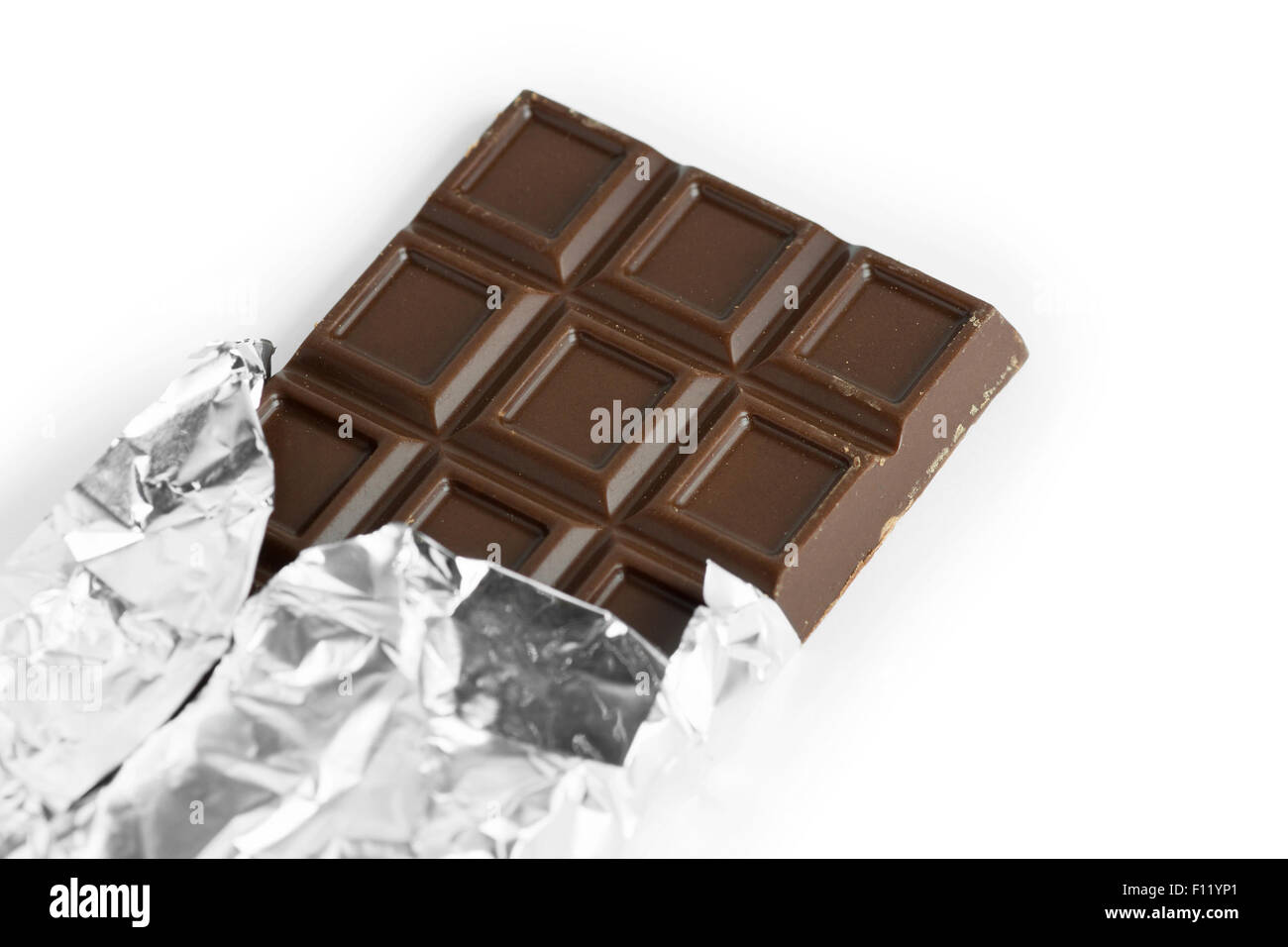Chocolate bar in foil on white background Stock Photo - Alamy