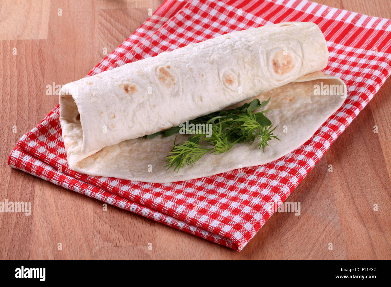 Burrito - Wheat flour tortilla wrapped around a filling Stock Photo