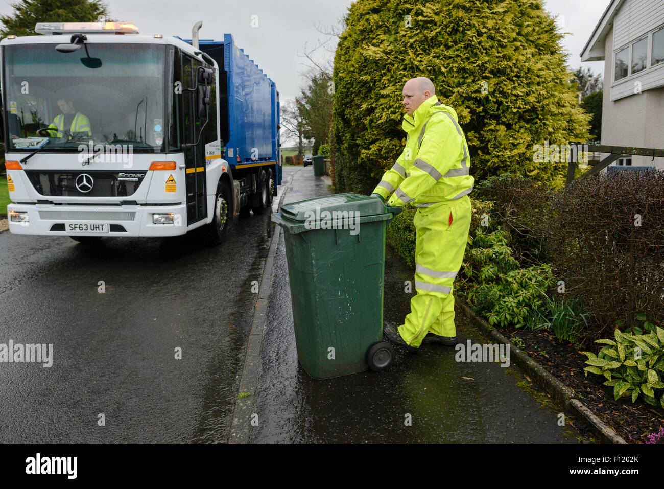 Bin men on thier refuse collection round in a small town in Scotland Stock Photo