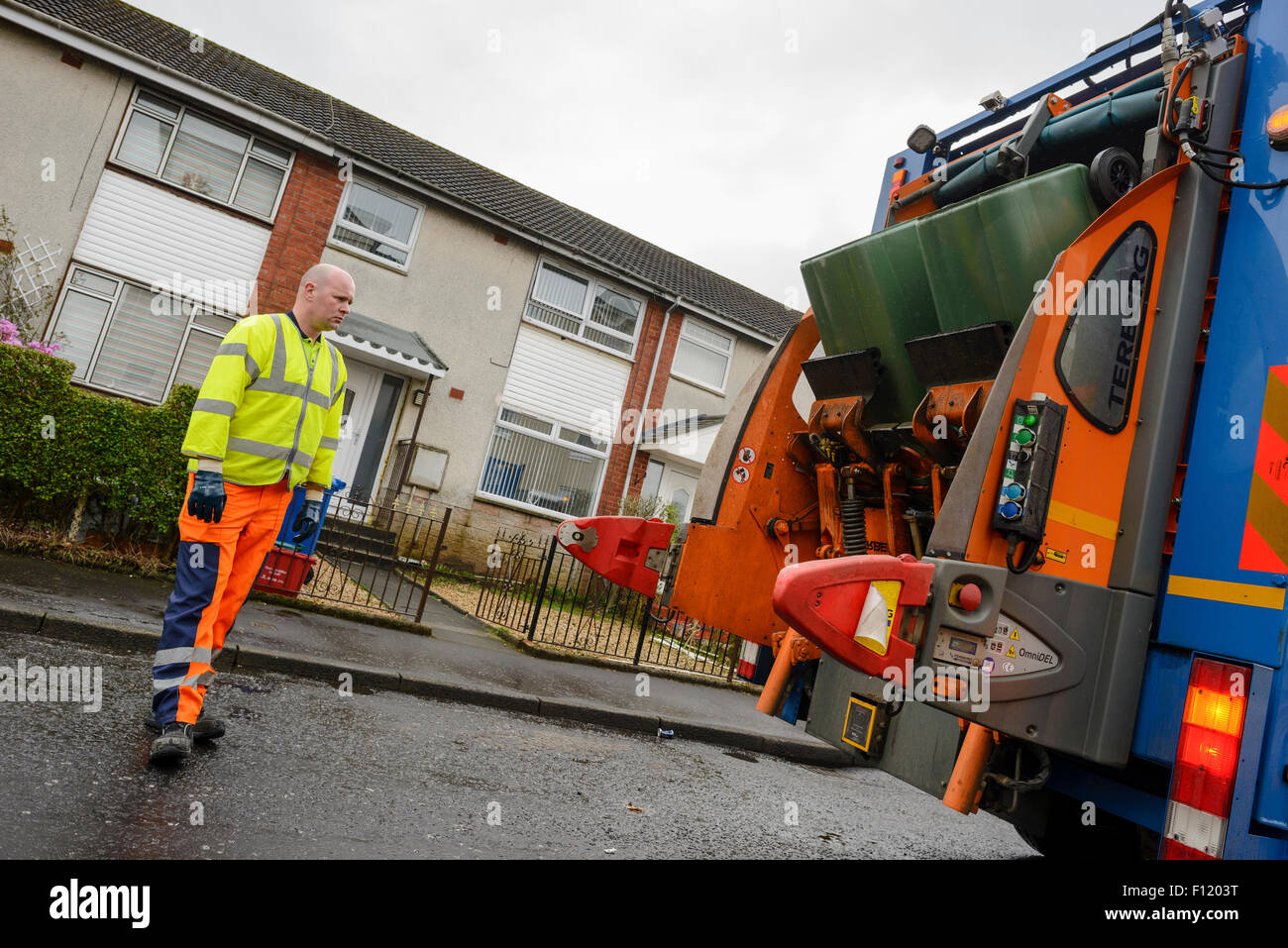 Bin men on thier refuse collection round in a small town in Scotland