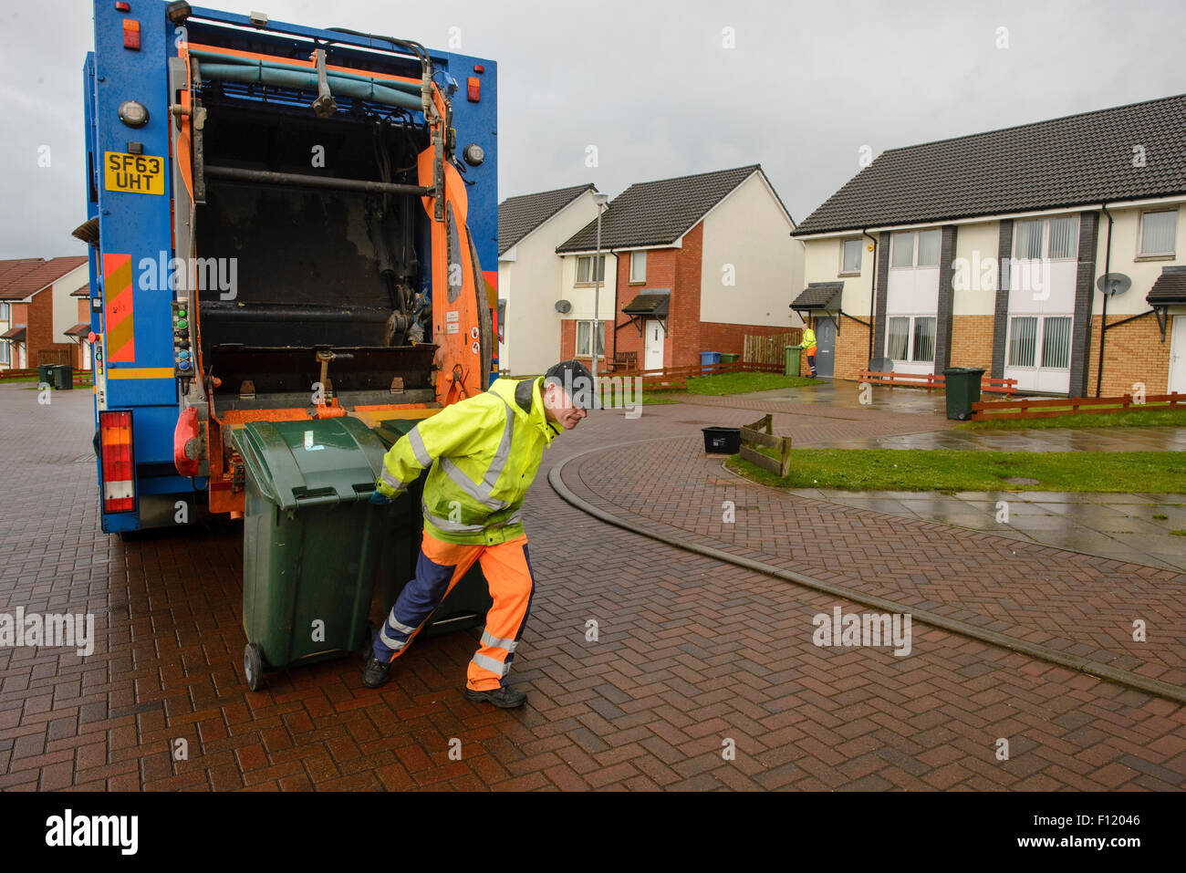 Bin men on thier refuse collection round in a small town in Scotland