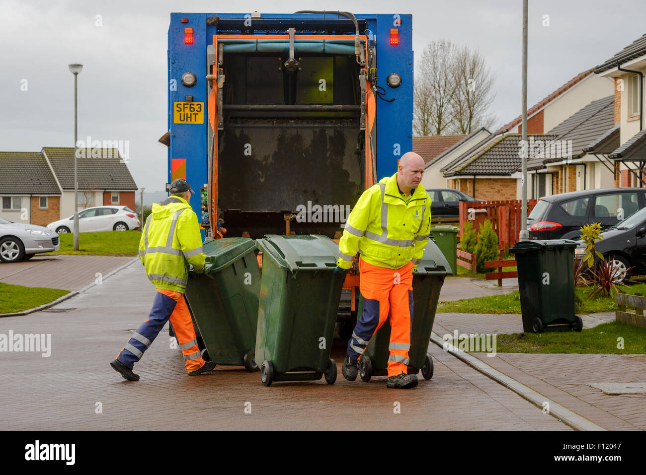 Bin men on thier refuse collection round in a small town in Scotland