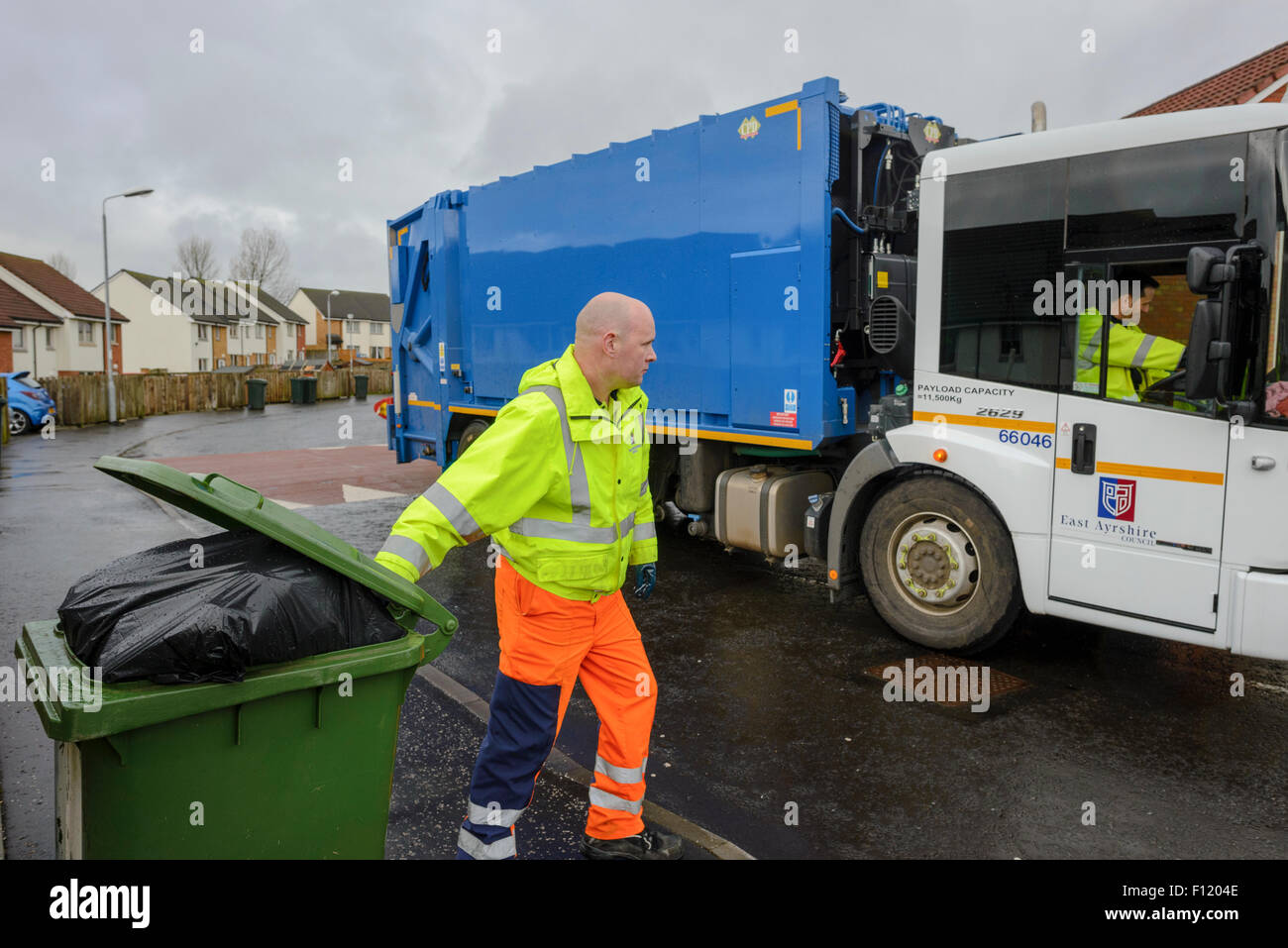Bin men on thier refuse collection round in a small town in Scotland