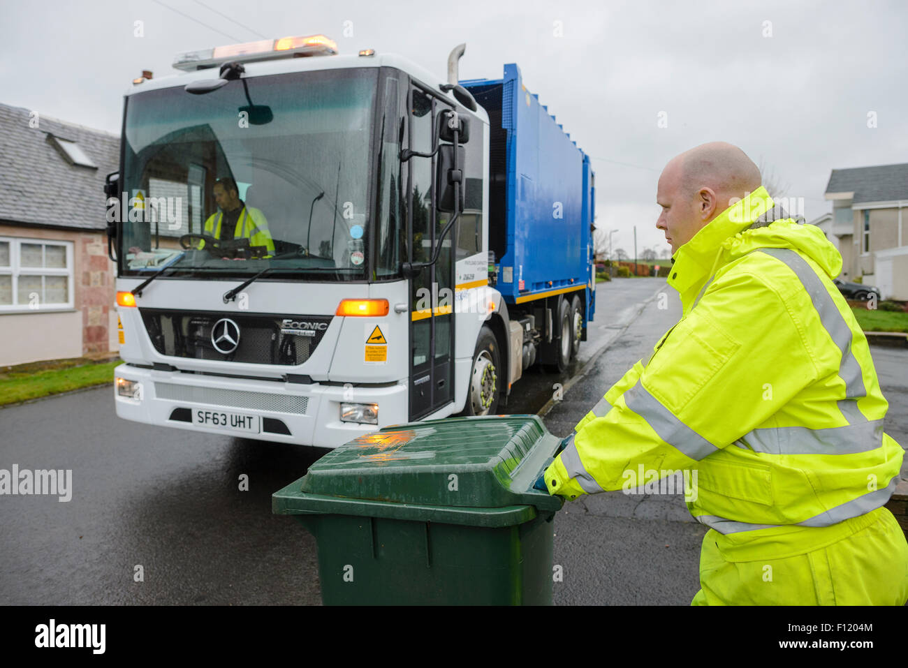 Bin men on thier refuse collection round in a small town in Scotland Stock Photo Alamy