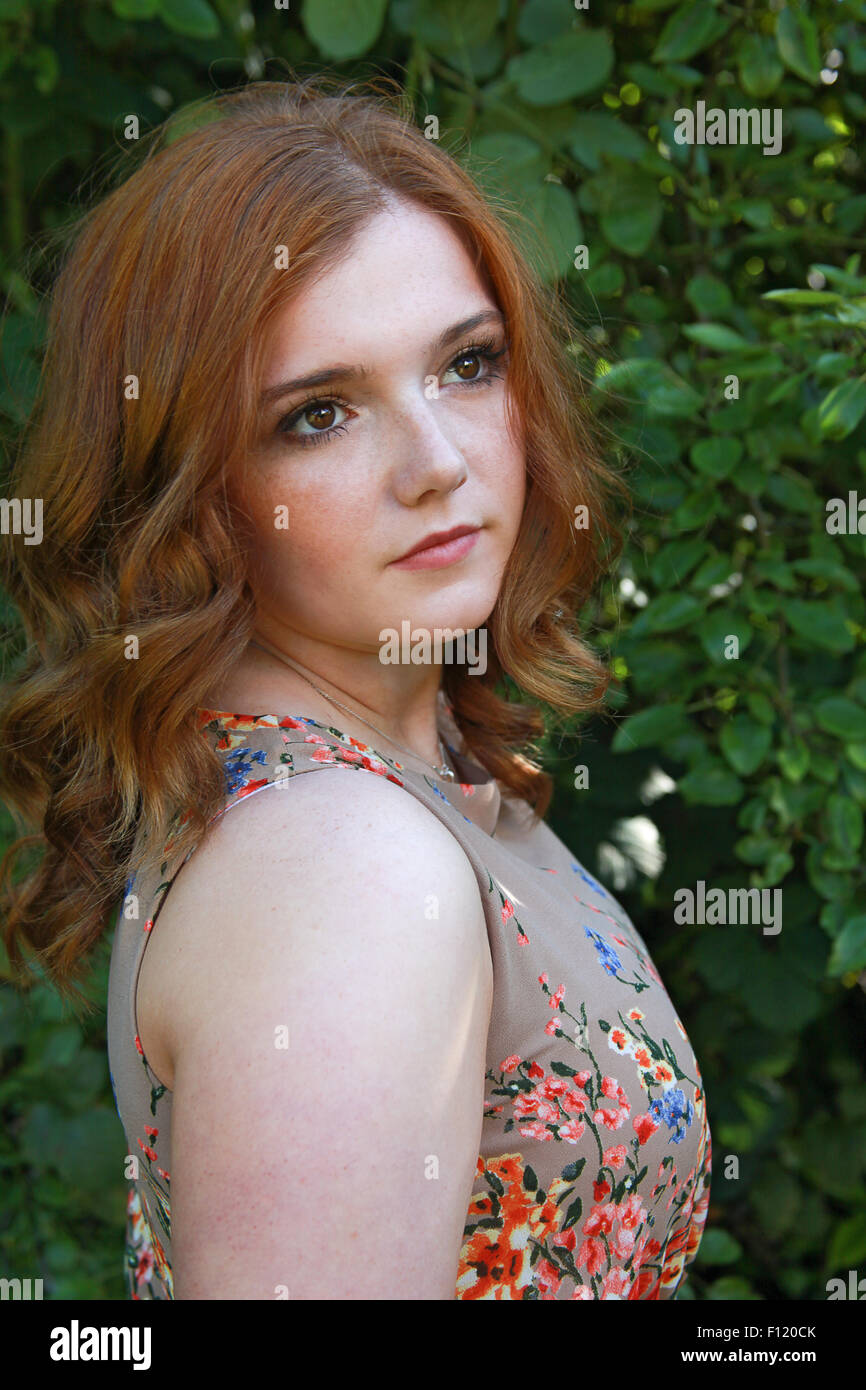 Beautiful young woman with red hair outdoors Stock Photo - Alamy