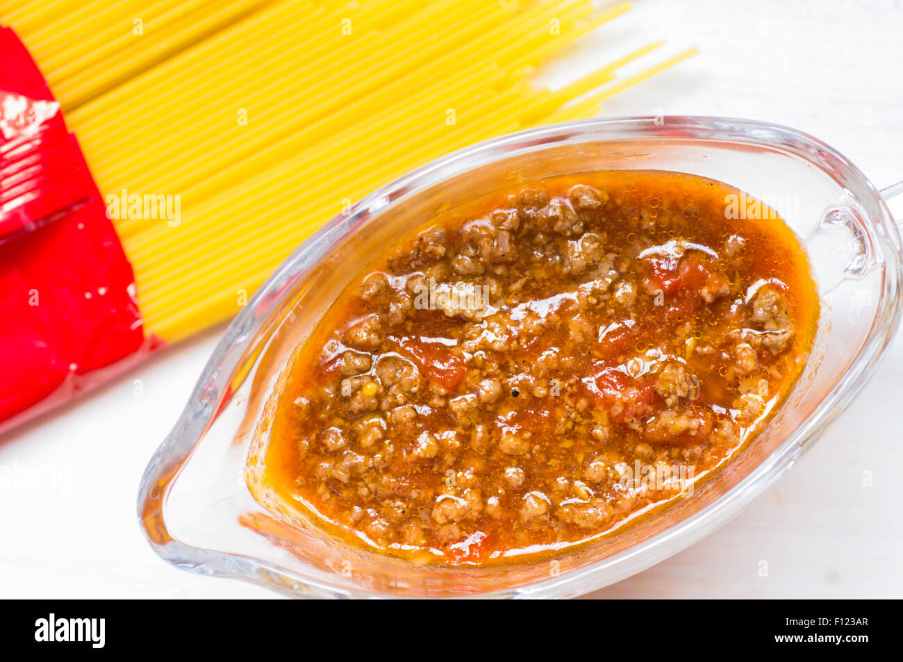 Bolognese sauce in a gravy boat near Spaghetti top view Stock Photo Alamy