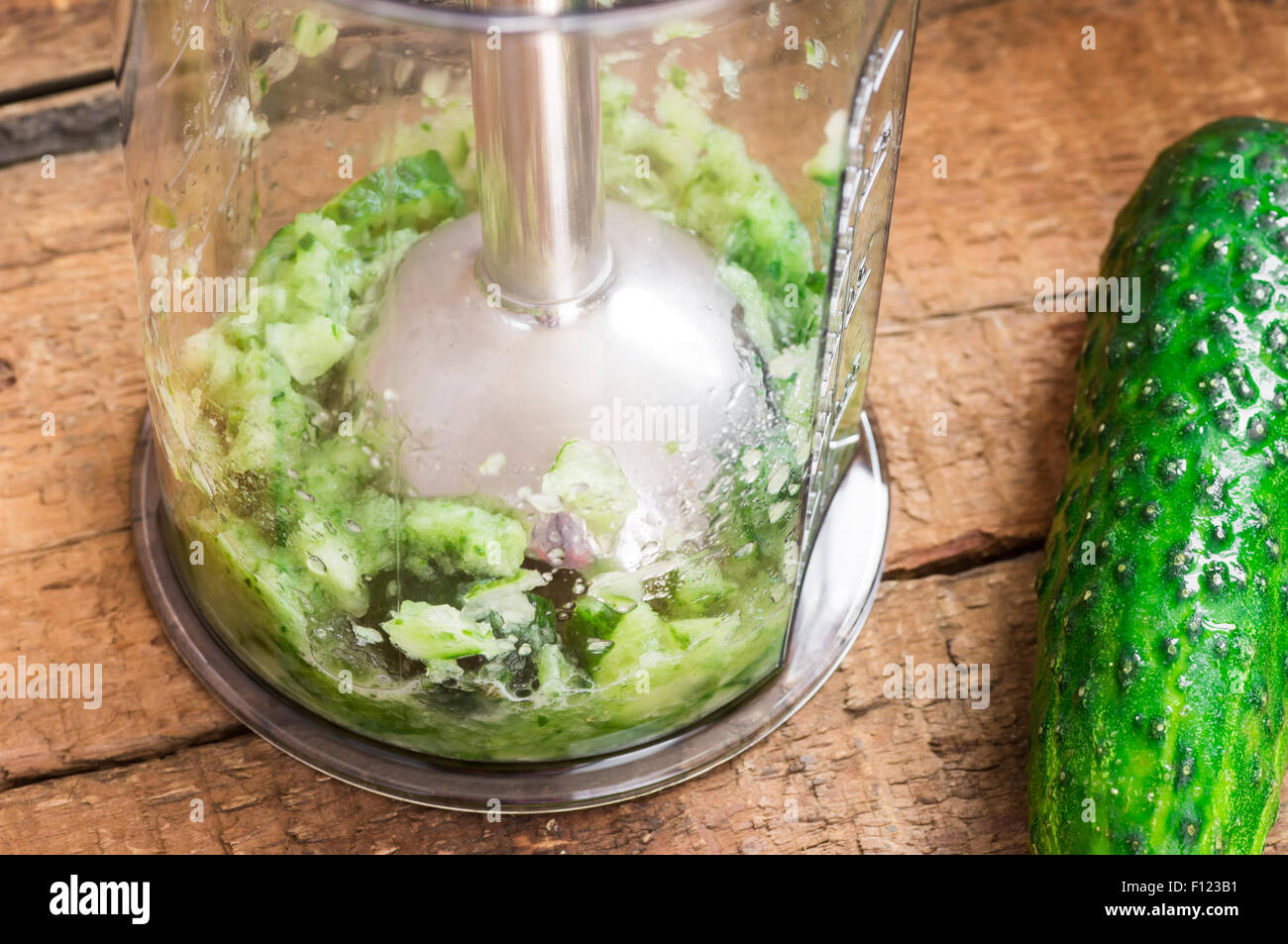 Chopping fresh cucumber hand blender Stock Photo - Alamy