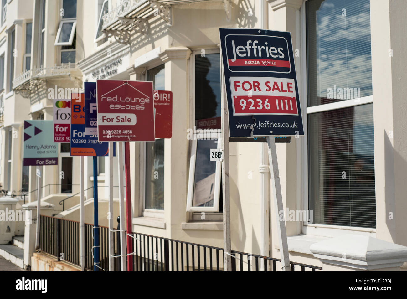 Several For Sale signs outside property Stock Photo