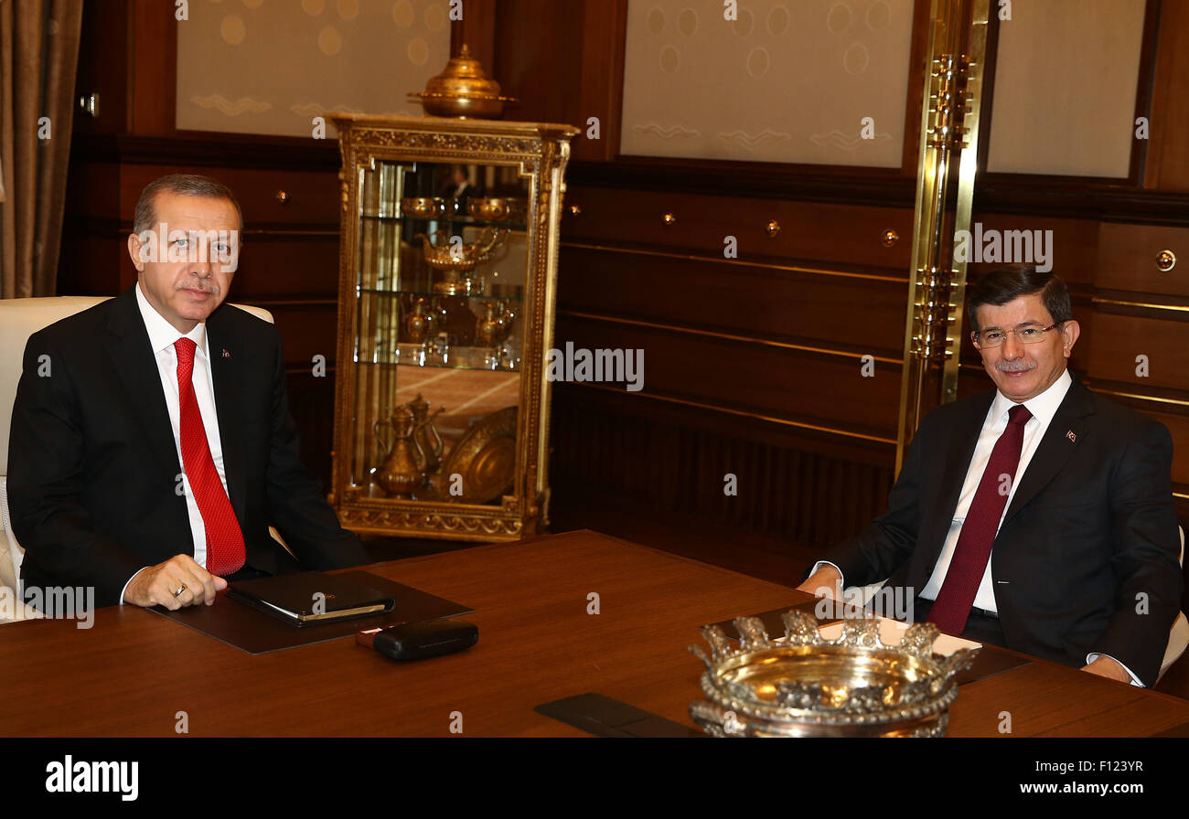 (150825) -- ANKARA, Aug. 25, 2015 (Xinhua) -- Turkish President Recep Tayyip Erdogan (L) meets with Prime Minister Ahmet Davutoglu in Ankara, Turkey, Aug. 25, 2015. Erdogan on Tuesday gave mandate to Davutoglu to form a caretaker government which will lead the country to a new election, the presidency office said in a statement. (Xinhua) (zjy) Stock Photo