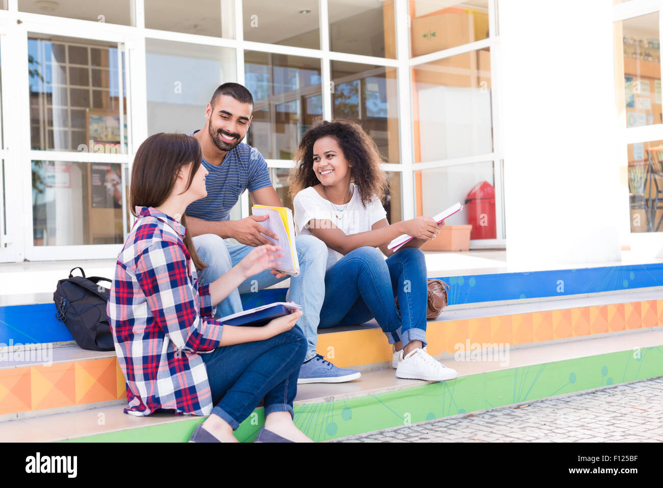 Group of students sitting on school stairs Stock Photo - Alamy