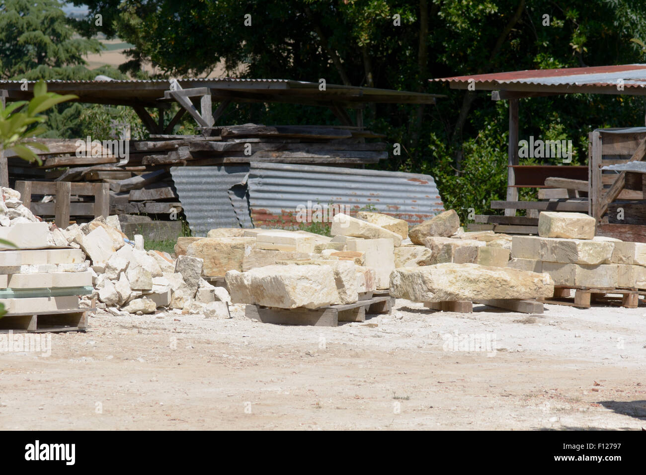 Large stones stacked in piles to be used to build house in St Thomas de Conac, Charentes region, France Stock Photo