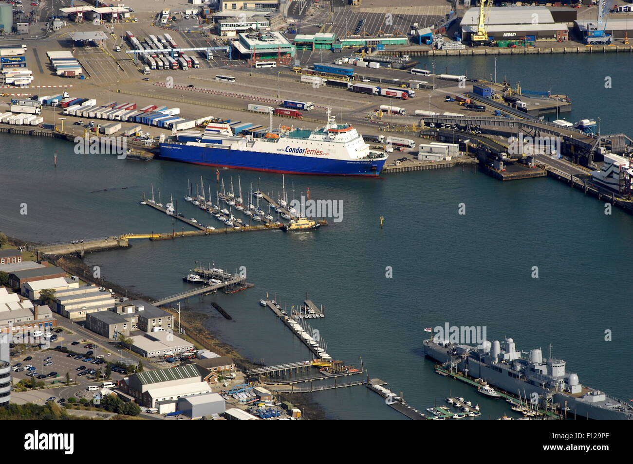 AJAXNETPHOTO. -  24TH AUGUST, 2011. PORTSMOUTH, ENGLAND. - FERRY PORT - COMMODORE GOODWILL ALONGSIDE AT THE COMMERCIAL FREIGHT QUAY, HMS BRISTOL LOWER RIGHT. PHOTO:JONATHAN EASTLAND/AJAX REF:D2X110209 1552 Stock Photo