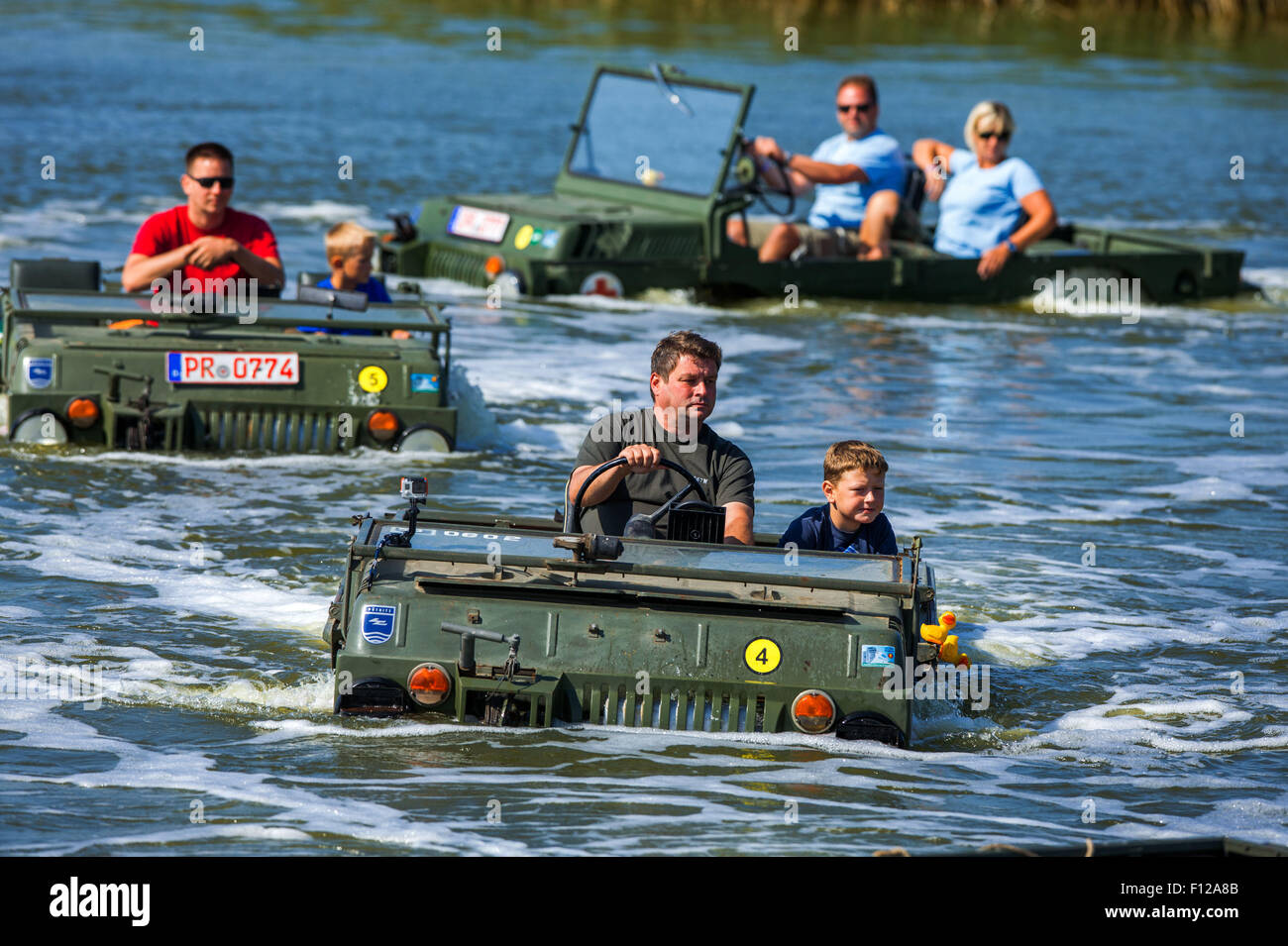 Ribnitz-Damgarten, Germany. 22nd Aug, 2015. LUAZ amphibious vehicles in action at the 9th Maritimer Fahrzeugtreffen (Maritime Vehicle Meet) at the Puetnitz former Russian airfield by the Saaler Bodden near Ribnitz-Damgarten, Germany, 22 August 2015. Military and civilian amphibious vehicles were on display at the meet, which is organised annualy by the Technik-Museum Puetnitz. PHOTO: JENS BUETTNER/DPA/Alamy Live News Stock Photo