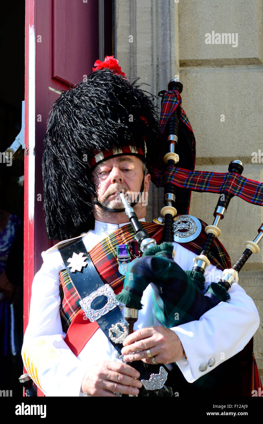 A piper playing the bagpipes. Stock Photo