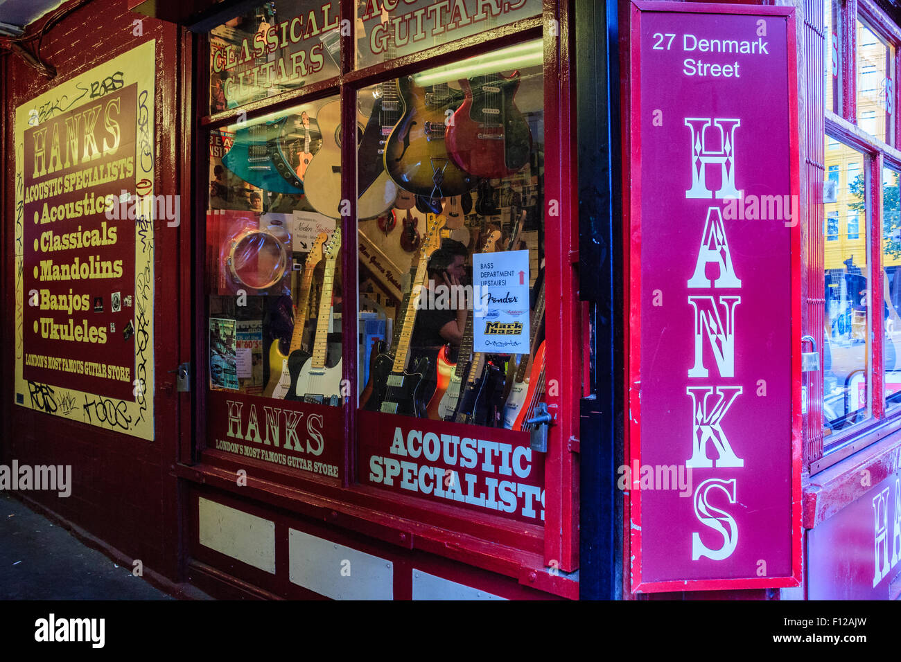 Guitars and instruments in the window of Hanks specialist music shop on Denmark Street, Soho, London aka Tin Pan Alley Stock Photo