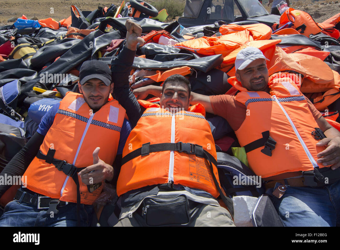 Lesbos, Greece. 25th Aug, 2015. Syrian refugees lay on a pile of life  jackets. More than 30,000 refugees have reached the Greek island of Lesvos  during August 2015, according to Amnesty International. ©