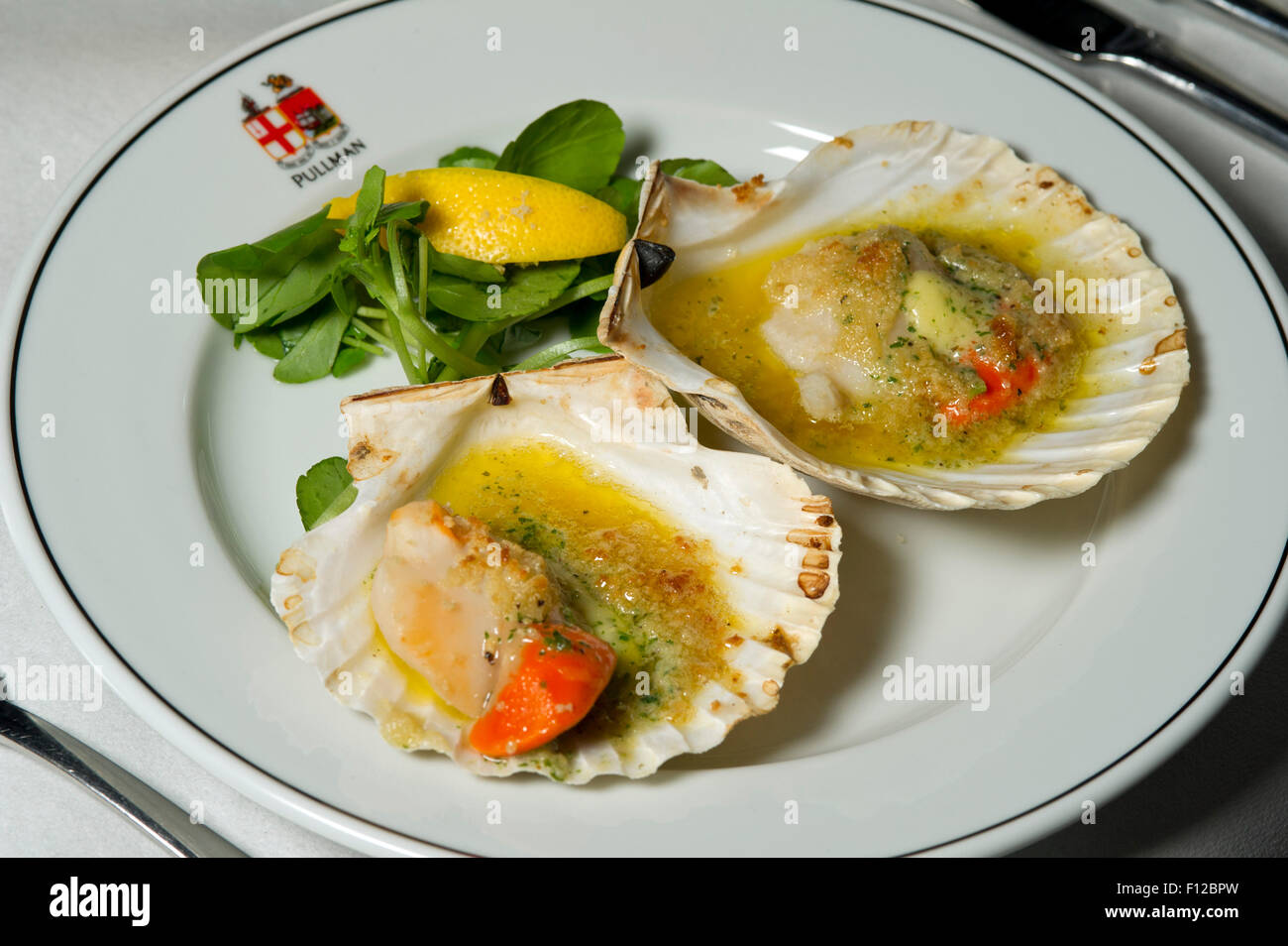 Devon scallops, garlic and white wine served on the First Great Western Pullman dining car. Stock Photo