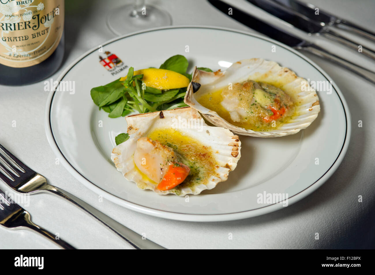 Devon scallops, garlic and white wine served on the First Great Western Pullman dining car. Stock Photo