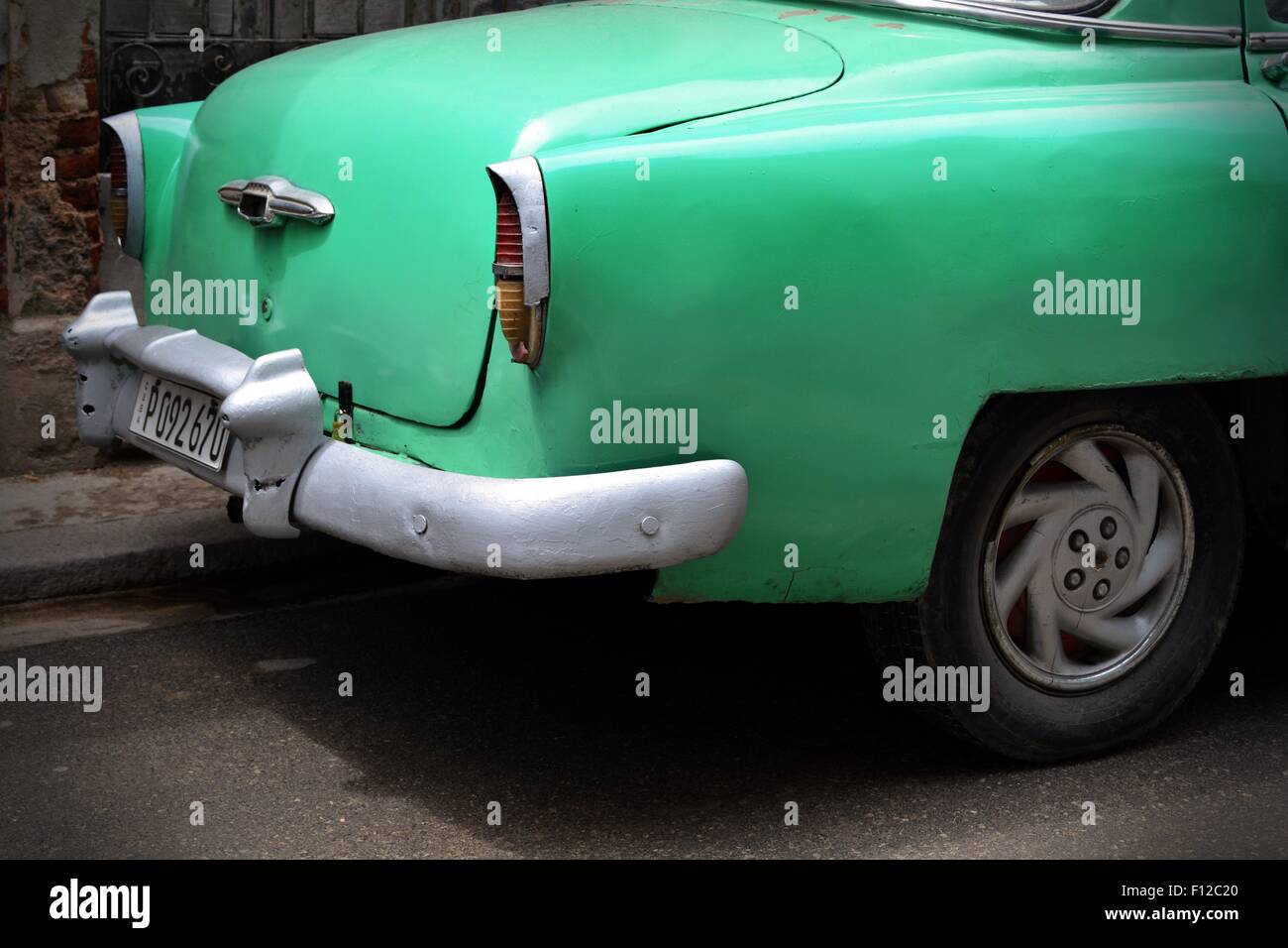 Rear end of a vintage car in Cuba in a 50's era shade of green, Havana. Stock Photo