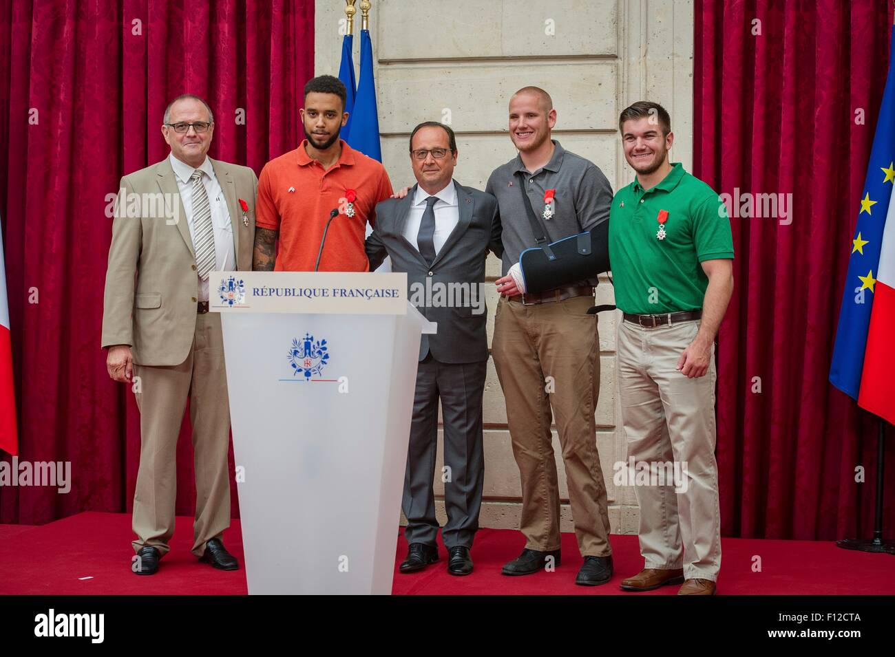 Paris, France. 24th Aug, 2015. French President Franois Hollande, center, poses with the four men who thwarted a terrorist attack on a French train after awarding the Legion of Honor at the Elysée Palace August 24, 2015 in Paris, France. (L to R): British businessman Chris Norman, Anthony Sadler Spencer Stone and Aleksander Skarlatos. Stock Photo