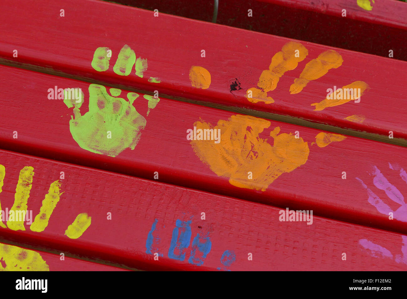 Colorful hand prints on park bench Stock Photo - Alamy