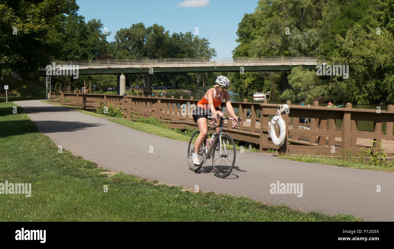 Lady biking on Erie Canal bike path. Stock Photo
