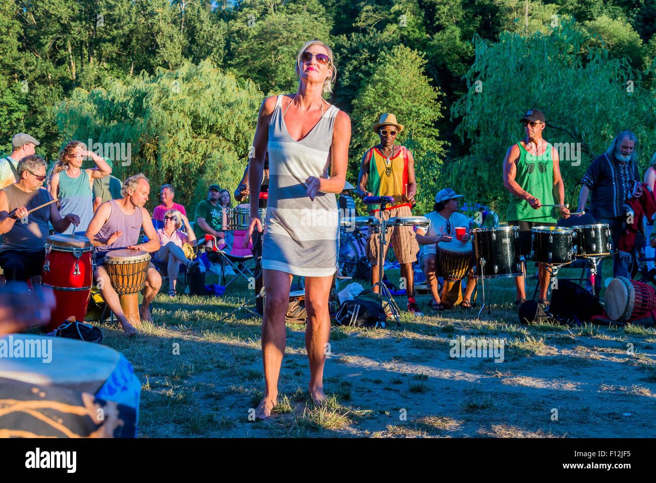 Woman dances to the rhythm of a Drum Circle, Spanish Banks beach, Vancouver, British Columbia, Canada, Stock Photo
