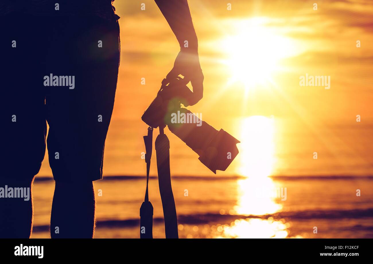 Sunset Photography. Photographer Ready to Take Sunset Pictures on the Beach. Professional Travel Photography Works. Stock Photo