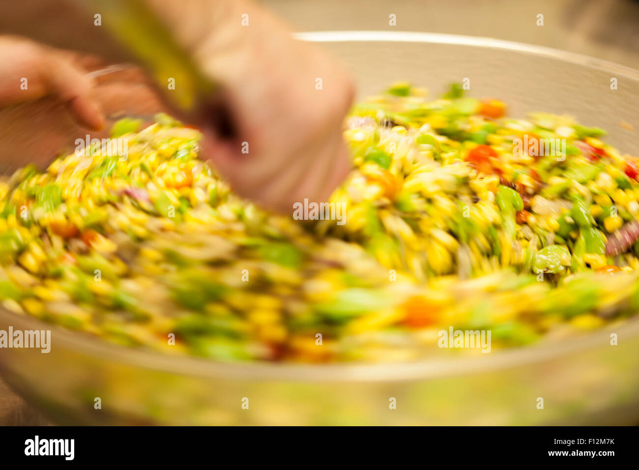 chef stirs a bowl of succotash for Members’ Dinner at Roblar Winery, Santa Ynez Valley, California Stock Photo