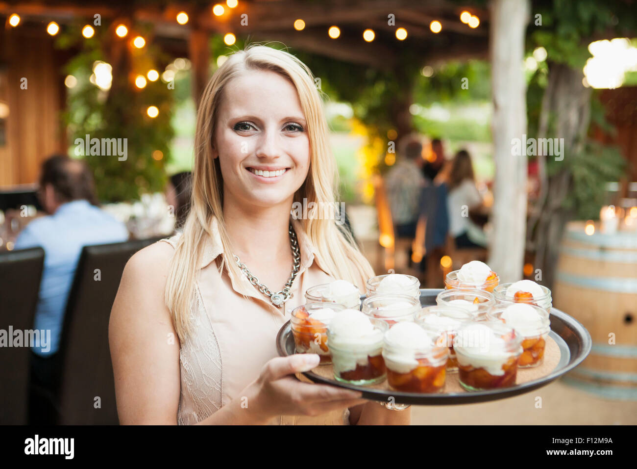 hostess serves dessert at the Members’ Dinner at Roblar Winery, Santa Ynez Valley, California Stock Photo