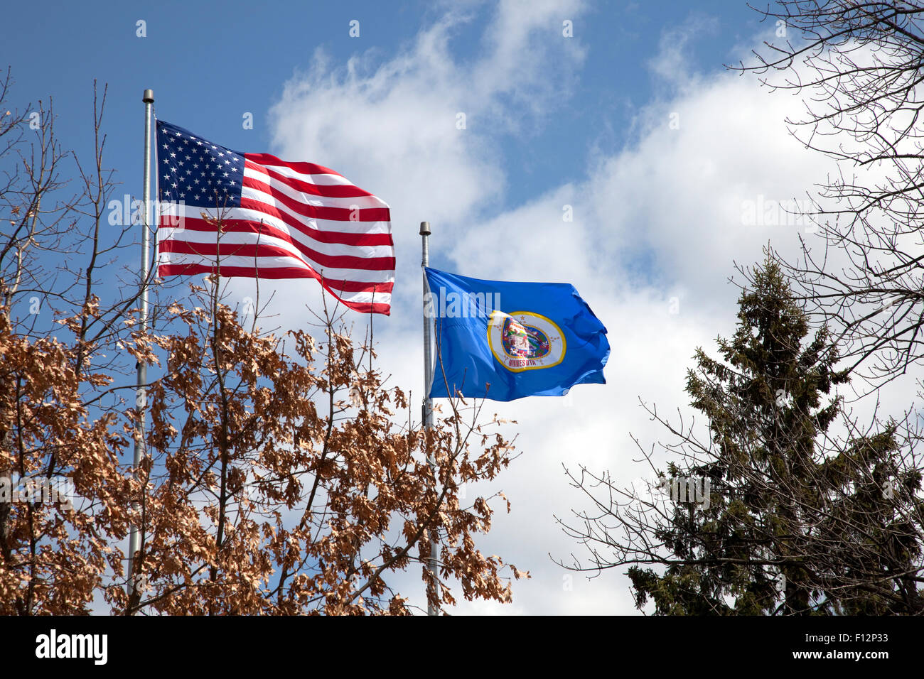 United States and Minnesota State flags flying briskly on a beautiful autumn day. St Paul Minnesota MN USA Stock Photo