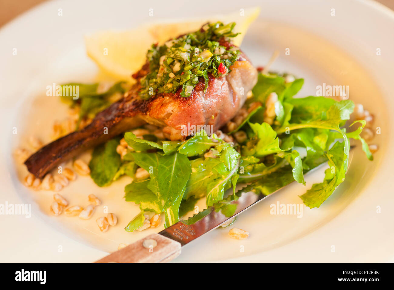 prosciuttowrapped artichoke stuffed with burrata cheese on a bed of