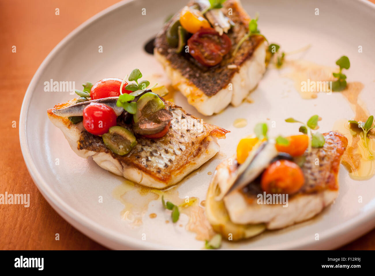 striped bass with cherry tomatoes, olives and anchovy, Tydes Restaurant