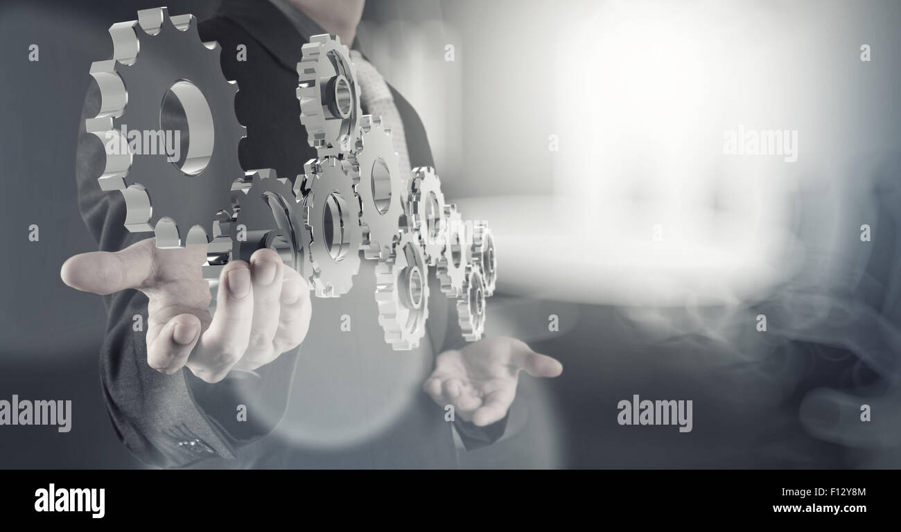 businessman hand shows 3d cog gear to success concept Stock Photo - Alamy