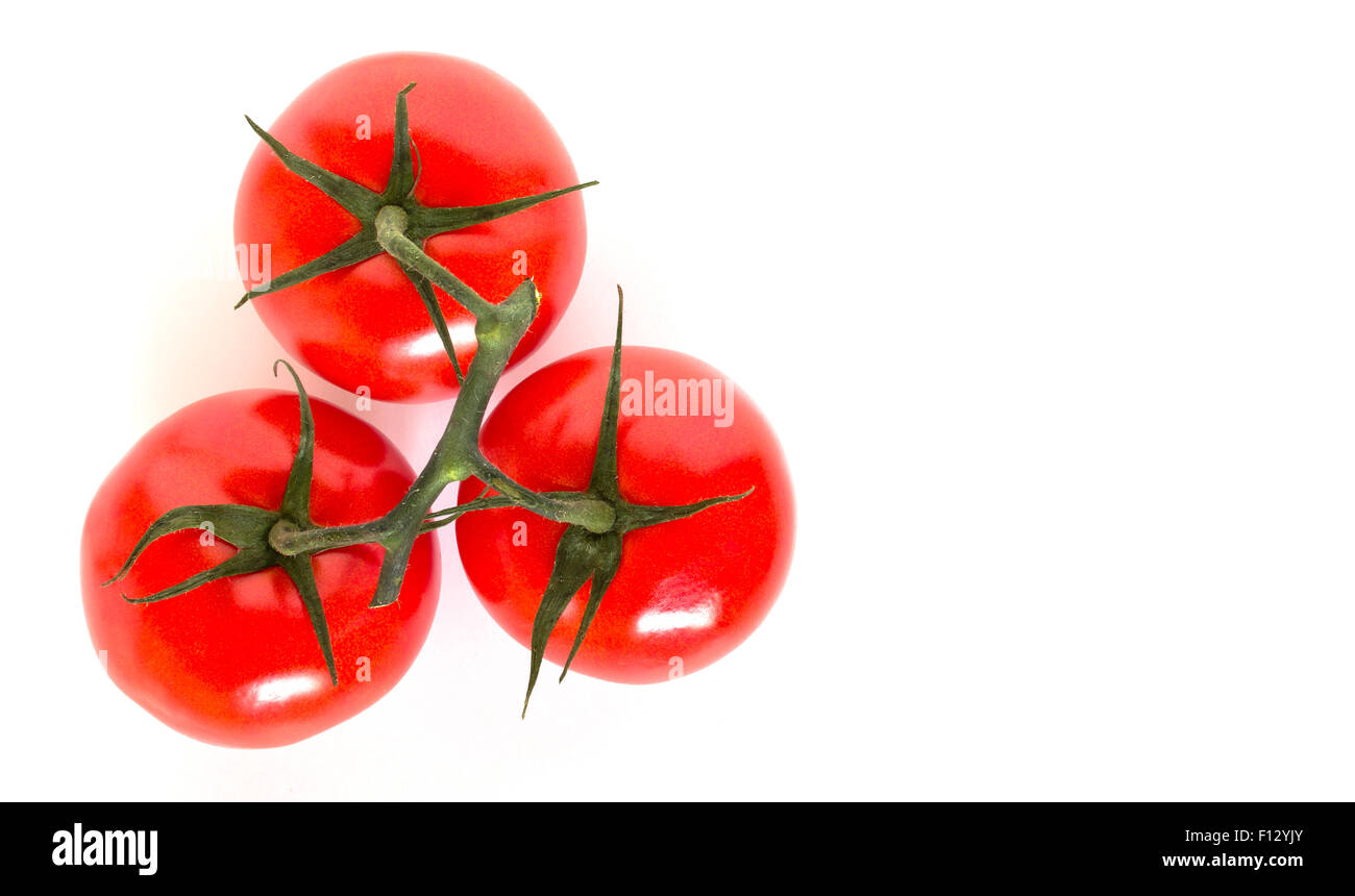 Three ripe tomatoes viewed from above and isolated on white background ...