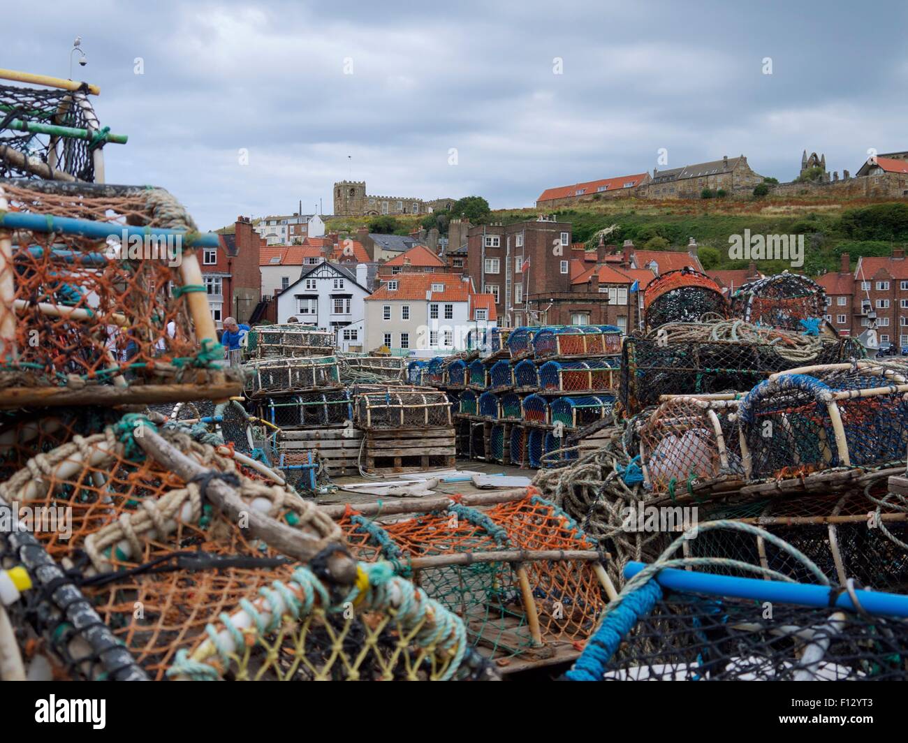 Lobster pots and traps with a church and houses in the background. Stock Photo