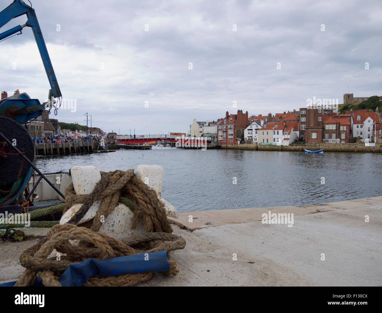Harbor with rope in the foreground and a swing bridge in the background Stock Photo