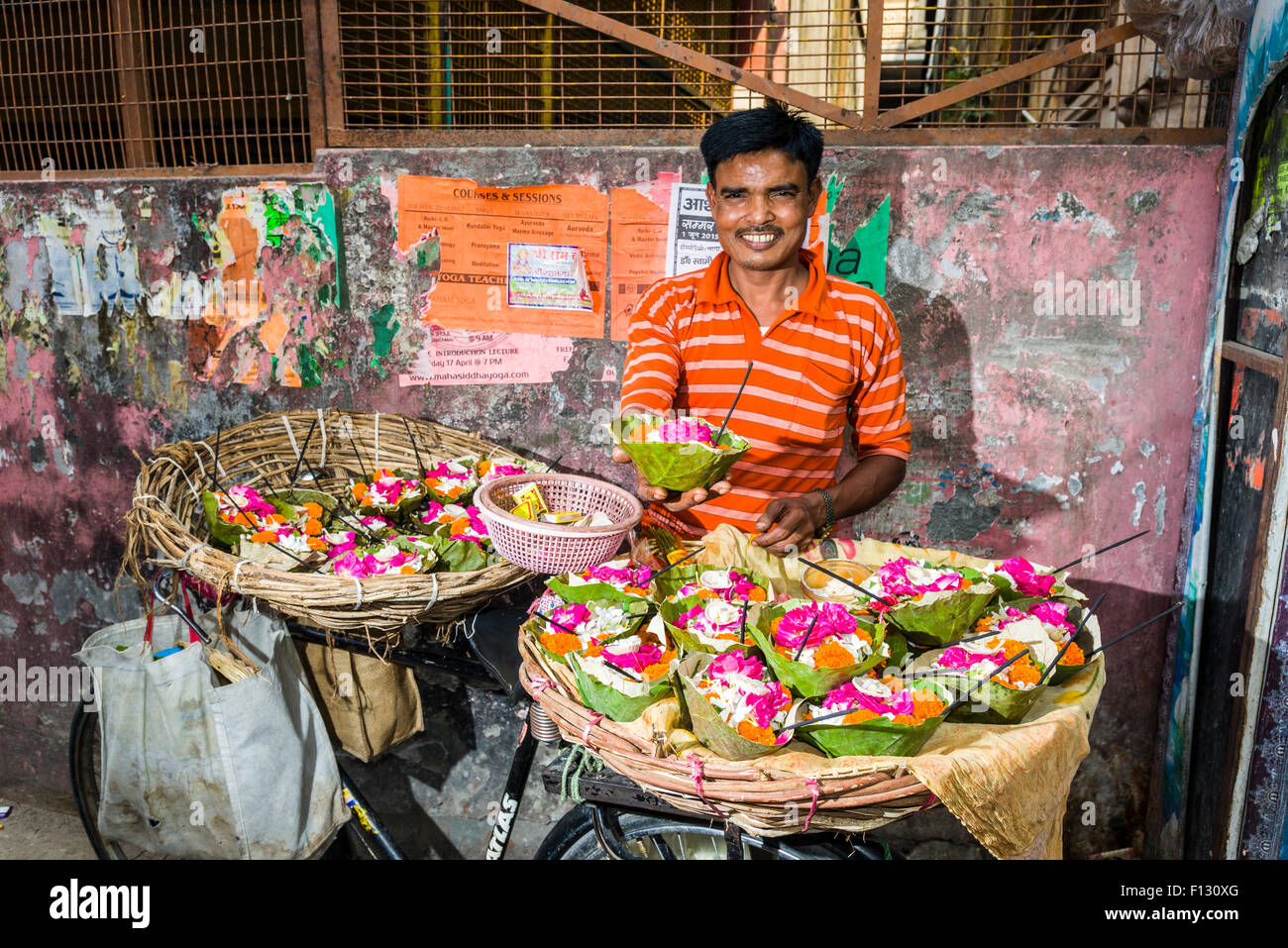 A man is selling deepaks, flower offerings, from a kart in the market, Rishikesh, Uttarakhand, India Stock Photo