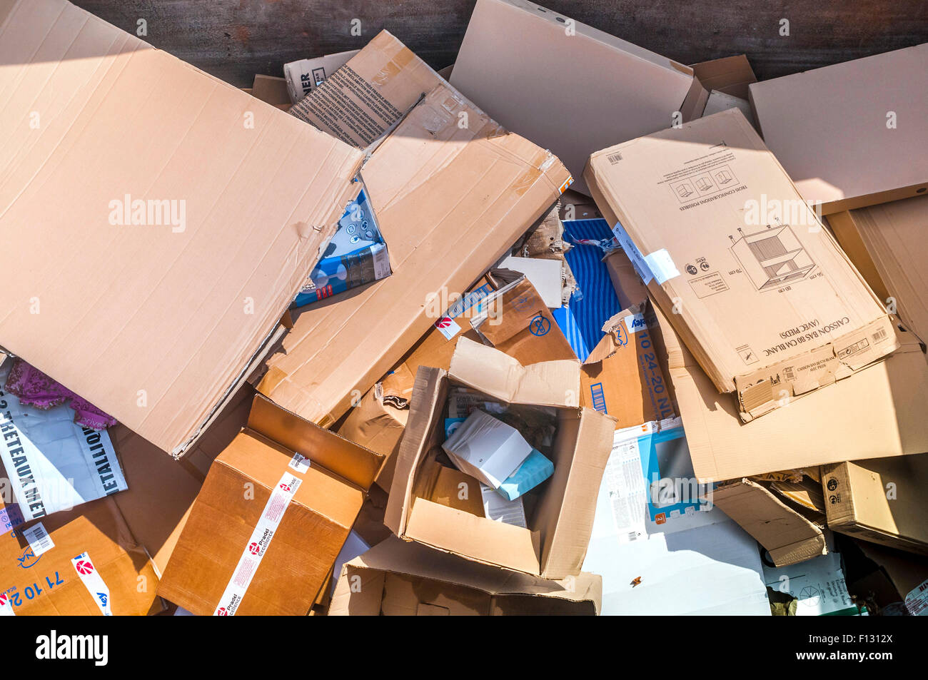 Cardboard cartons in rubbish skip - France. Stock Photo