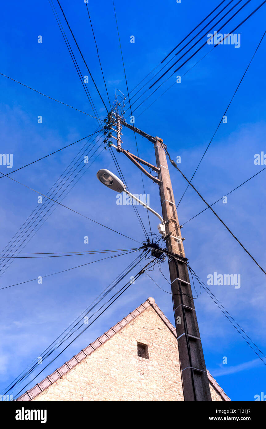 Jumble of overhead telephone and electricity wires on post - France Stock  Photo - Alamy