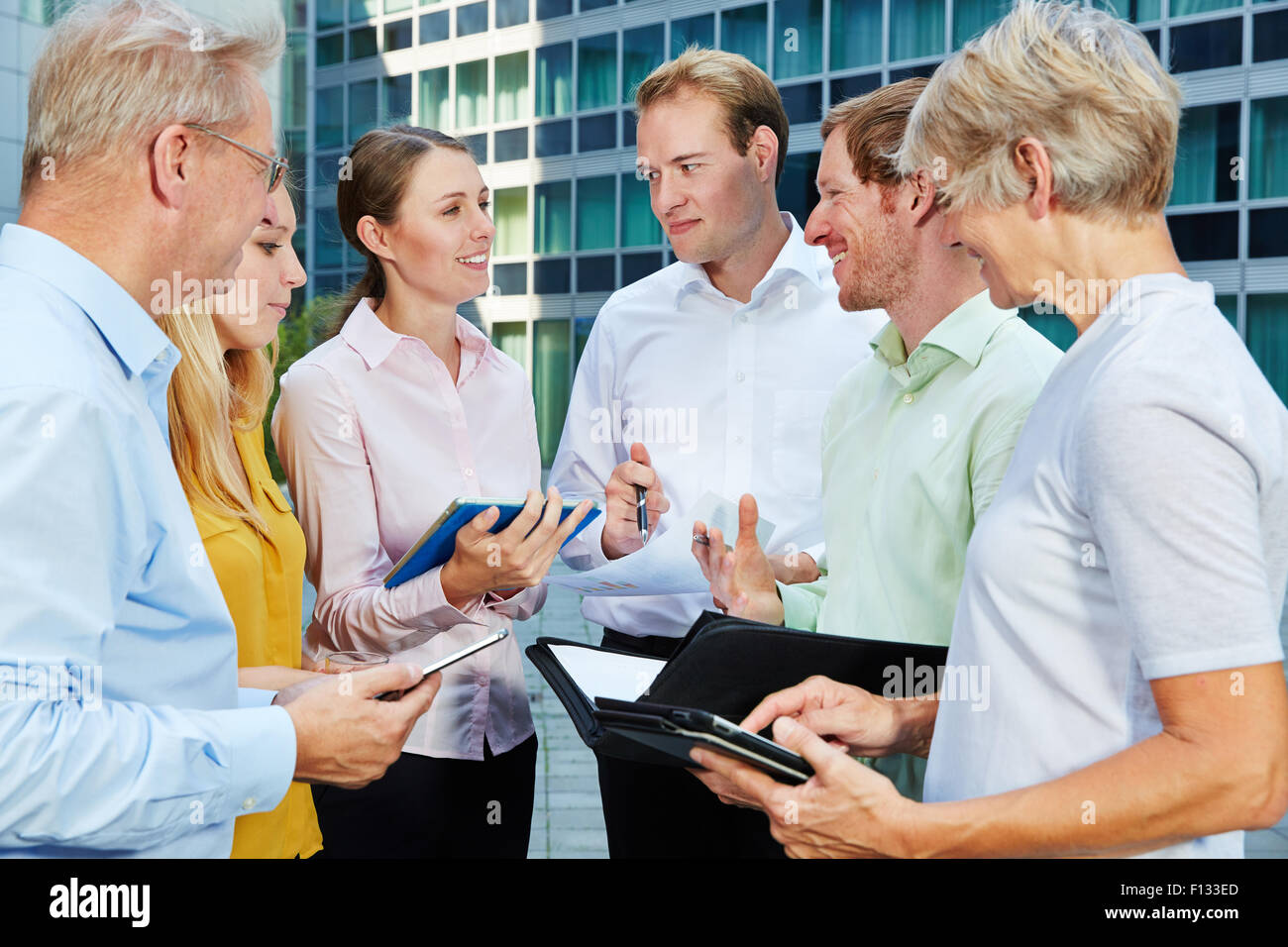 Business people talking and working together with a tablet PC Stock Photo