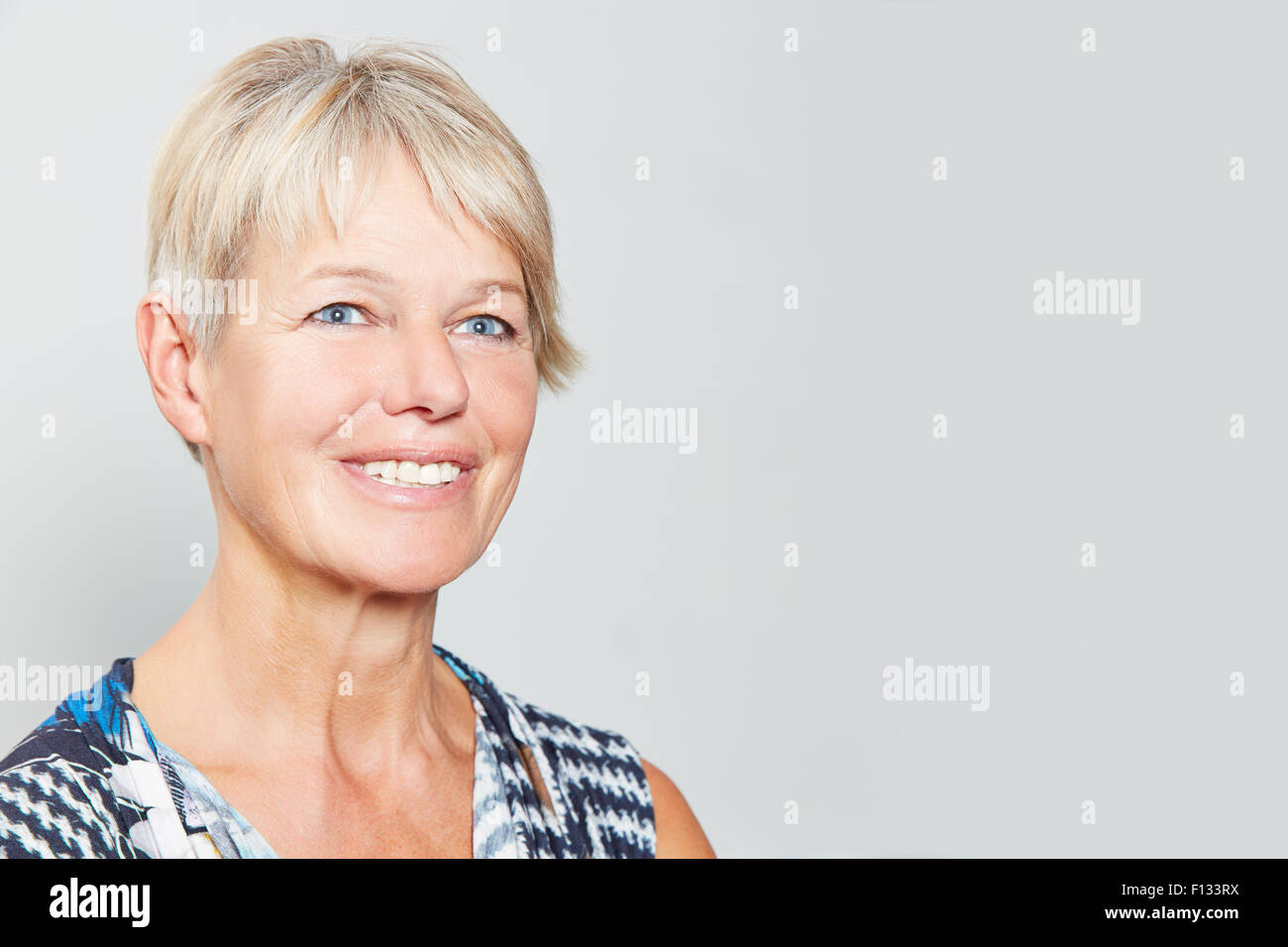 Smiling happy senior woman with grey hair Stock Photo - Alamy