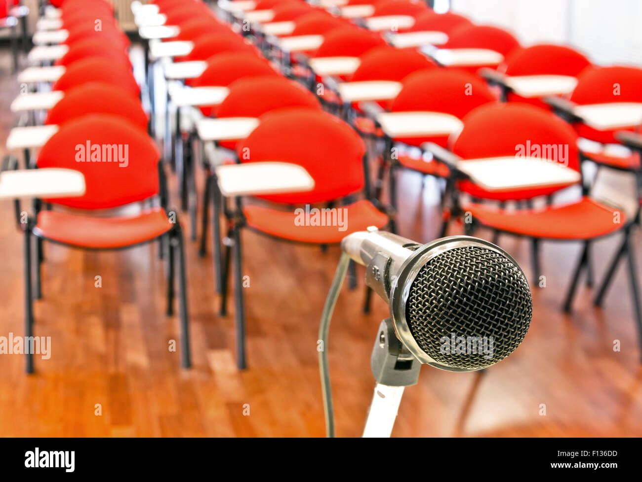 Close up of microphone in front of empty chairs in conference room Stock Photo
